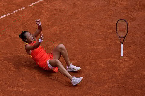 Zheng Qinwen celebrates after defeating Iga Swiatek